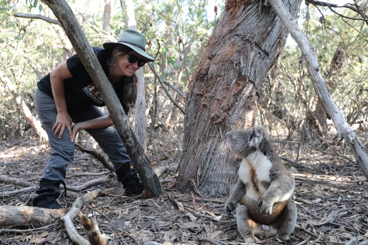 Karen holding a koala in the woods